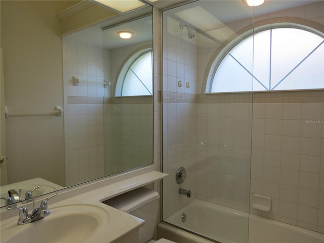 full bathroom featuring vanity, toilet, and combined bath / shower with glass door