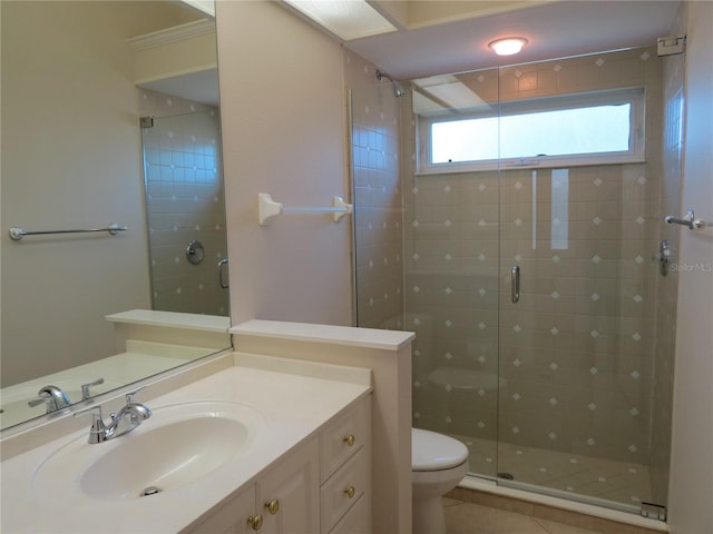 bathroom with vanity, tile patterned flooring, toilet, and walk in shower