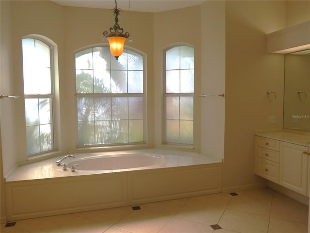 bathroom featuring vanity, tile patterned floors, and a tub