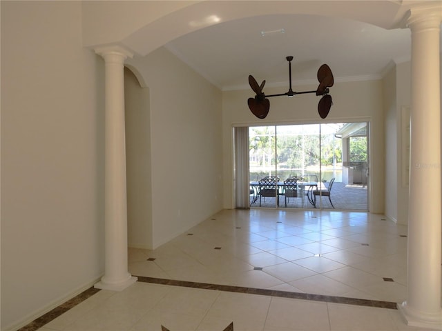 empty room with crown molding, light tile patterned floors, and ornate columns