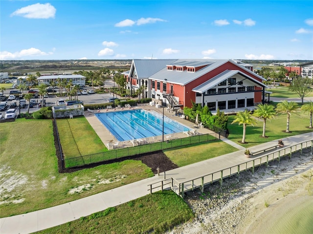 view of swimming pool featuring a lawn