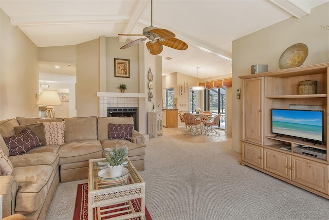 carpeted living room with vaulted ceiling with beams, ceiling fan, and a fireplace