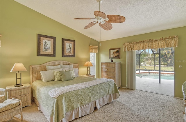 carpeted bedroom featuring access to outside, ceiling fan, lofted ceiling, and a textured ceiling