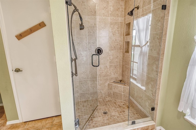 bathroom featuring tile patterned flooring and a shower with shower door