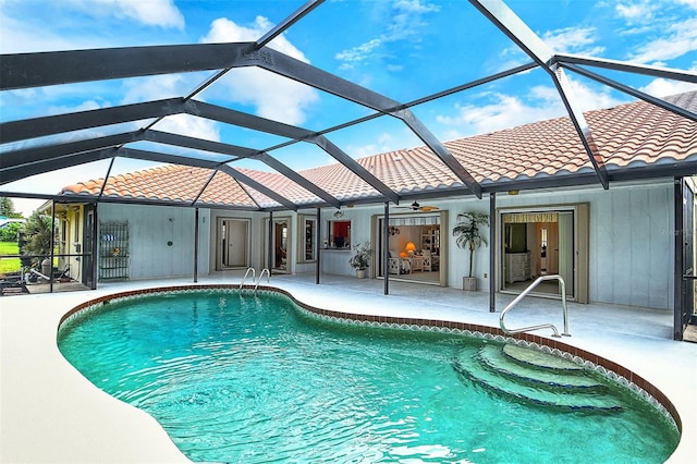 view of swimming pool featuring a lanai, a patio area, and ceiling fan