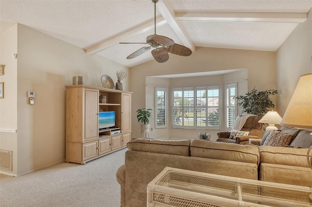 carpeted living room featuring a textured ceiling, lofted ceiling with beams, and ceiling fan