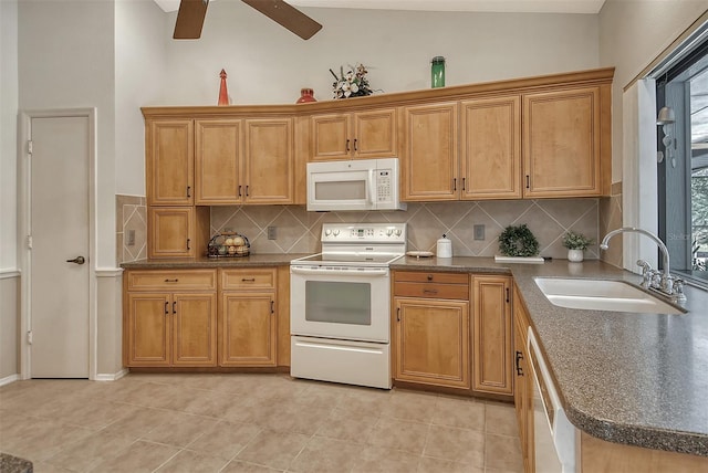 kitchen with backsplash, sink, light tile patterned floors, and white appliances