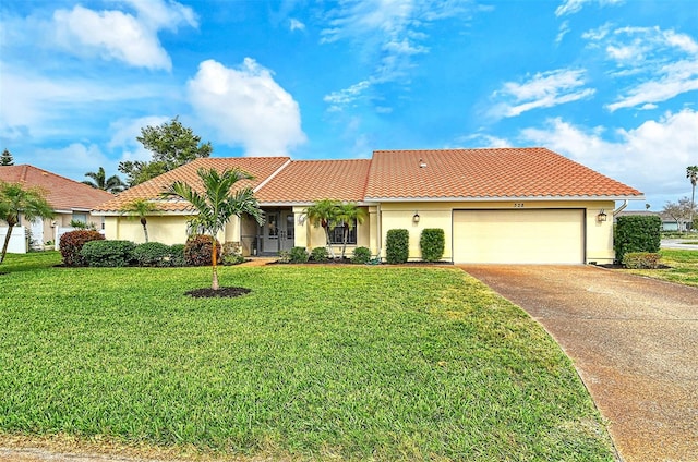 mediterranean / spanish-style home with a front yard and a garage