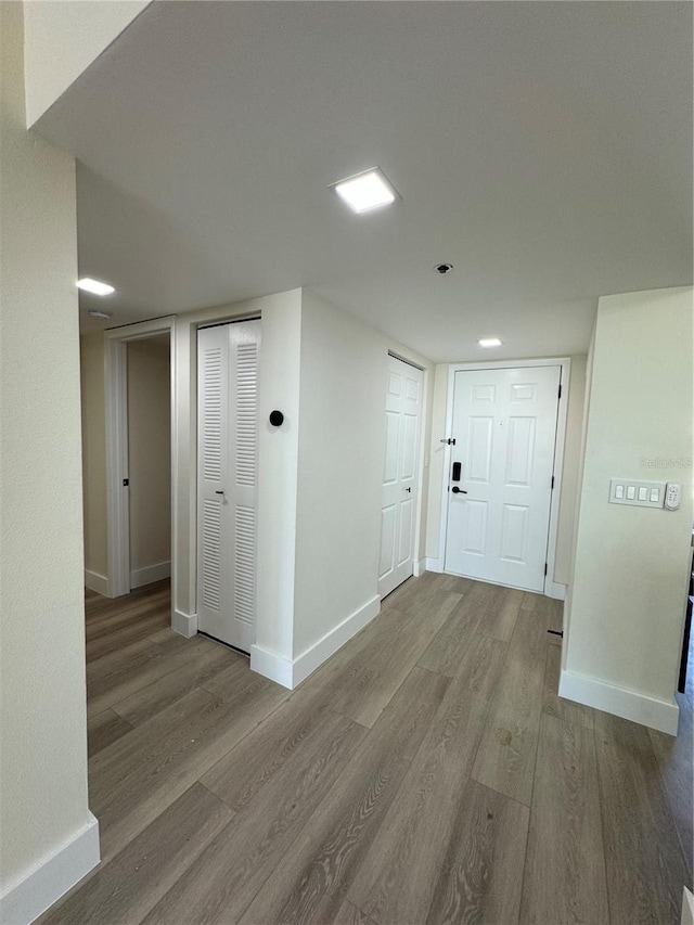 hallway with hardwood / wood-style flooring