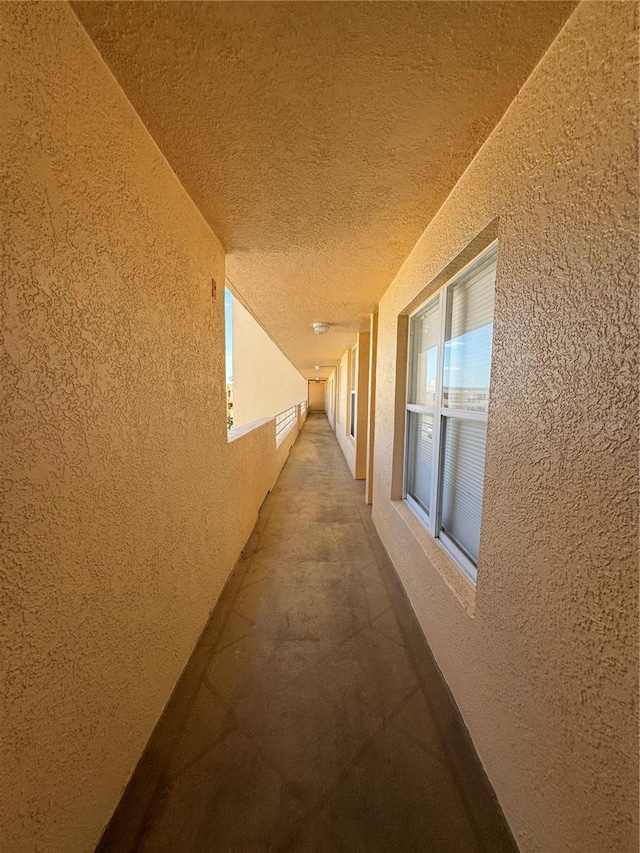 hall featuring a textured ceiling