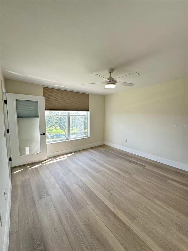 spare room featuring hardwood / wood-style floors and ceiling fan