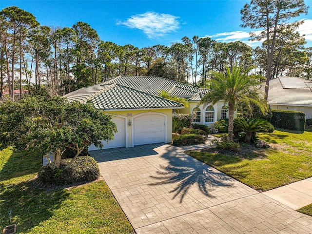 view of front of house with a front lawn and a garage