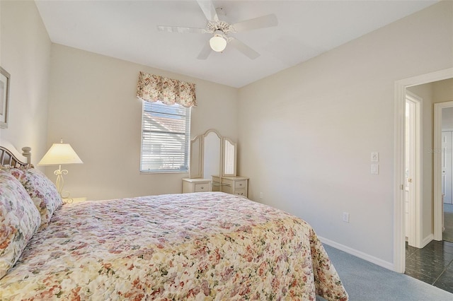 bedroom featuring ceiling fan and dark colored carpet