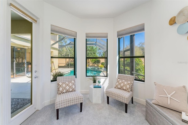 living area featuring light carpet