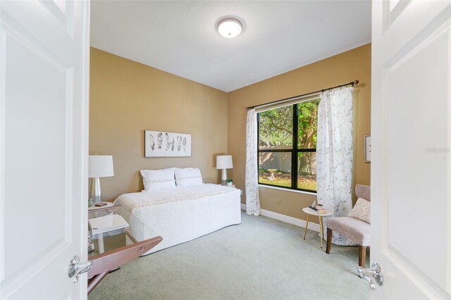 bedroom featuring light carpet