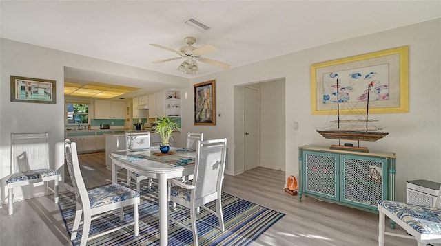 dining space featuring light hardwood / wood-style floors and ceiling fan