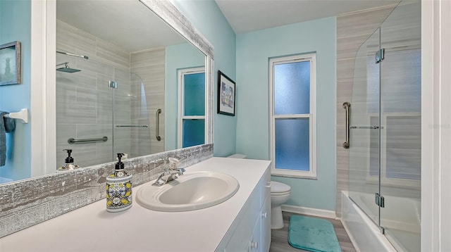 full bathroom featuring toilet, combined bath / shower with glass door, and oversized vanity