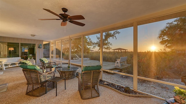 sunroom featuring ceiling fan