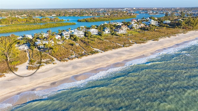 drone / aerial view with a water view and a view of the beach