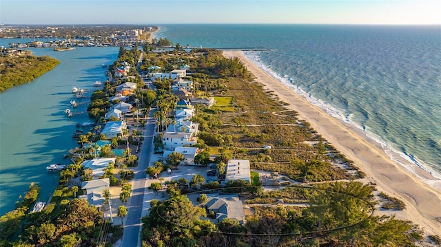 birds eye view of property with a water view and a beach view