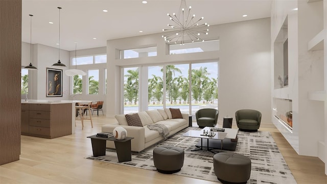 living room with a high ceiling, light hardwood / wood-style flooring, and a notable chandelier