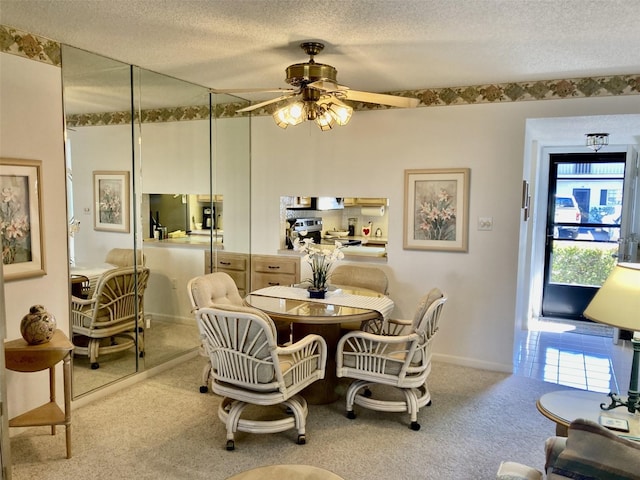 dining room with light carpet, a textured ceiling, and ceiling fan