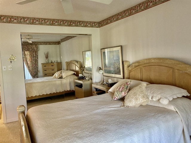 bedroom with ceiling fan and a textured ceiling