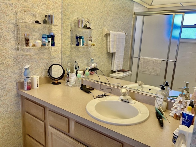 bathroom with large vanity and toilet