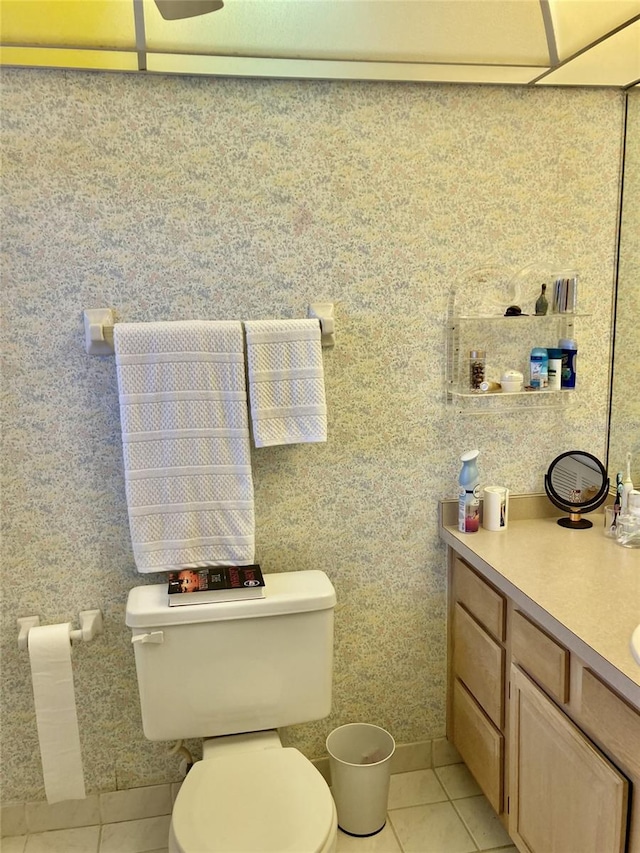 bathroom with vanity, tile flooring, and toilet