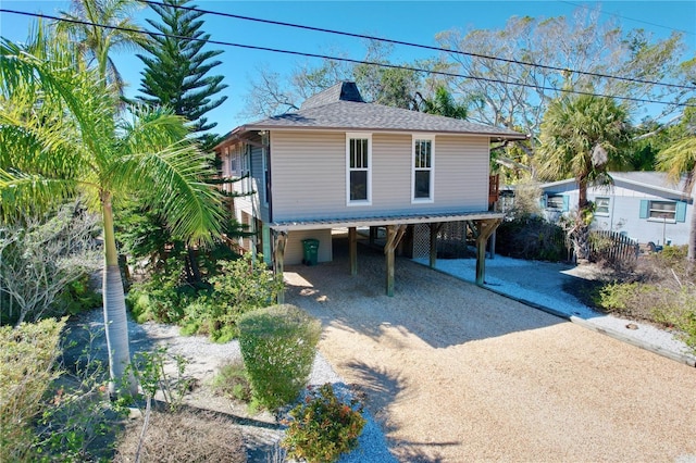 raised beach house featuring a carport