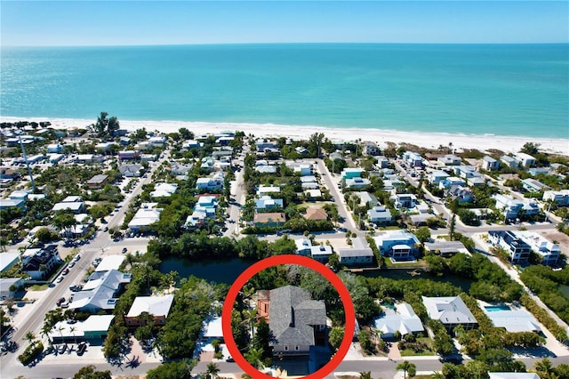 drone / aerial view with a water view and a beach view