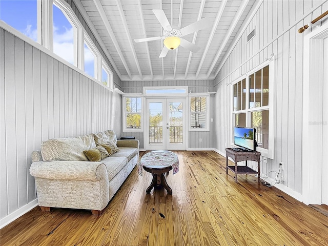 sunroom / solarium featuring wood ceiling, ceiling fan, french doors, and lofted ceiling with beams