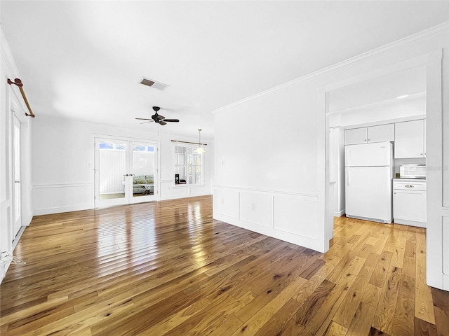 unfurnished living room with french doors, crown molding, ceiling fan, and light hardwood / wood-style flooring