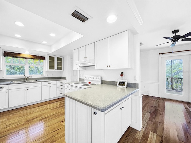 kitchen featuring ceiling fan, white cabinets, electric range, and light hardwood / wood-style flooring