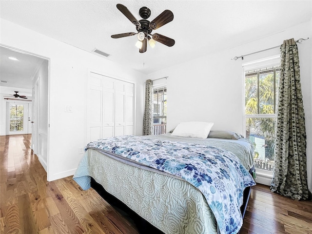 bedroom featuring a closet, ceiling fan, and hardwood / wood-style flooring