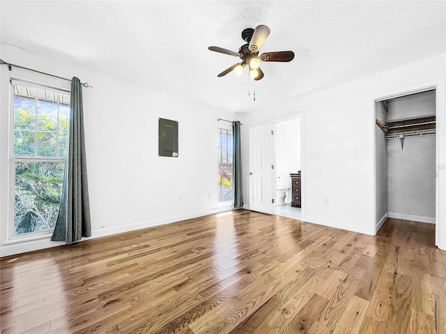 unfurnished bedroom featuring light hardwood / wood-style floors, a closet, and ceiling fan