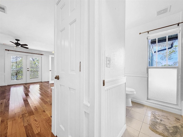 bathroom with french doors, toilet, tile floors, and ceiling fan