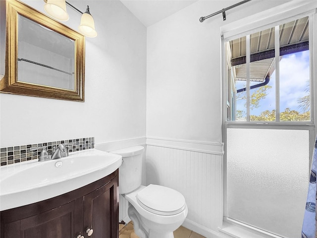 bathroom with backsplash, toilet, large vanity, and tile flooring