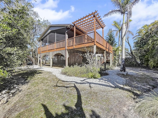 rear view of property featuring a pergola