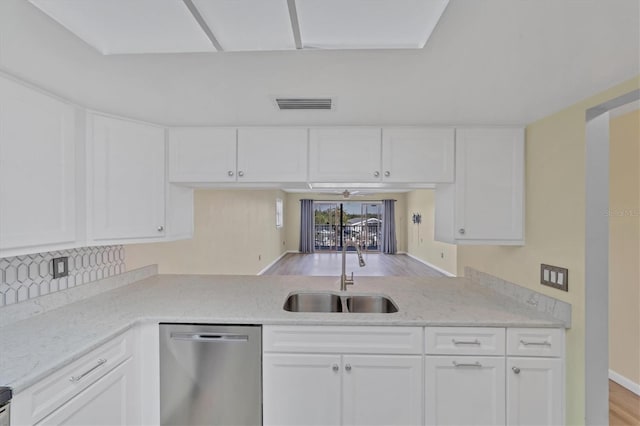 kitchen featuring stainless steel dishwasher, white cabinetry, light wood-type flooring, and sink