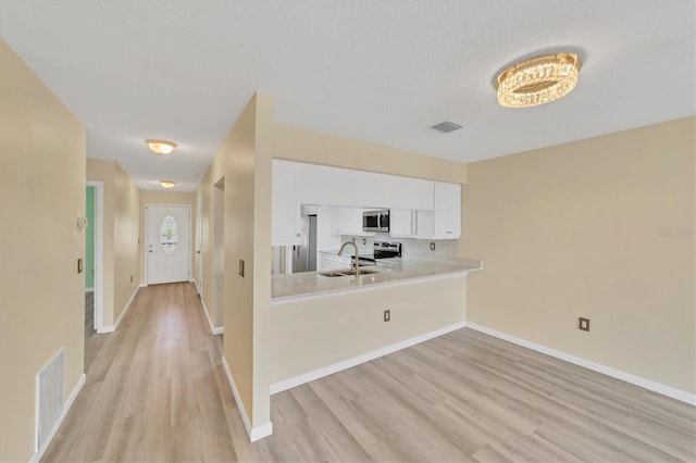 interior space with sink and light hardwood / wood-style flooring