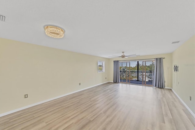 empty room with ceiling fan and light hardwood / wood-style flooring