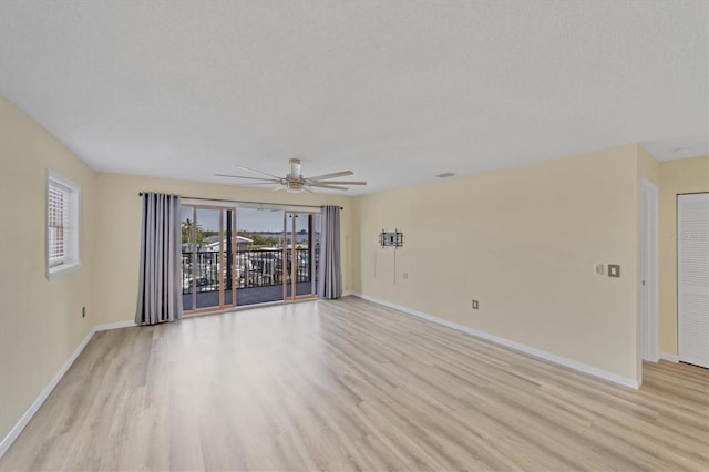 spare room featuring ceiling fan and light hardwood / wood-style flooring