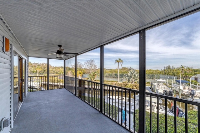 unfurnished sunroom featuring ceiling fan