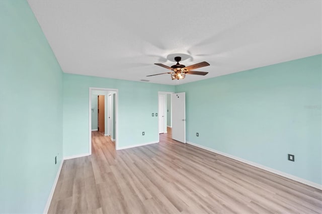 unfurnished bedroom with ceiling fan and light wood-type flooring