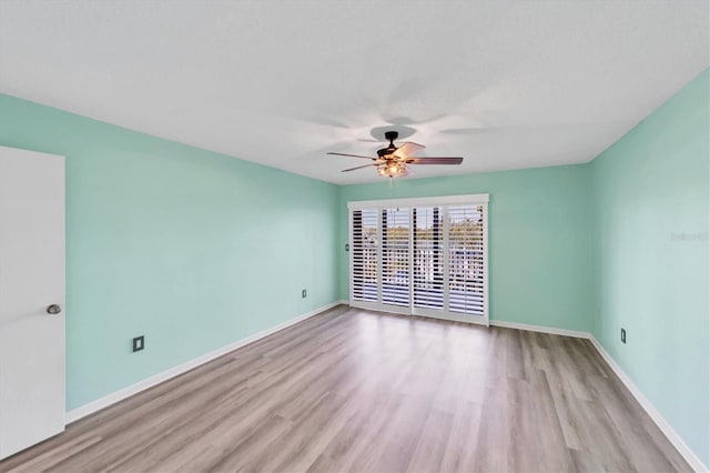 unfurnished room featuring ceiling fan and light hardwood / wood-style flooring