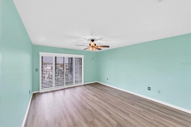 spare room featuring ceiling fan and dark hardwood / wood-style flooring