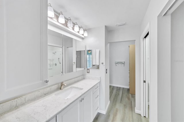 bathroom with oversized vanity and wood-type flooring