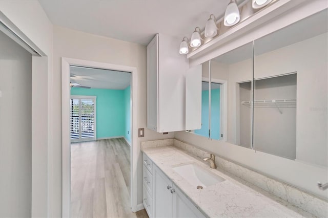 bathroom featuring hardwood / wood-style floors, vanity, and ceiling fan