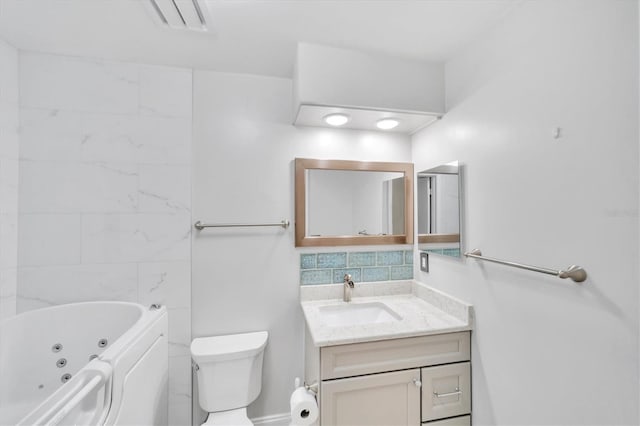 bathroom with toilet, vanity, and tile walls